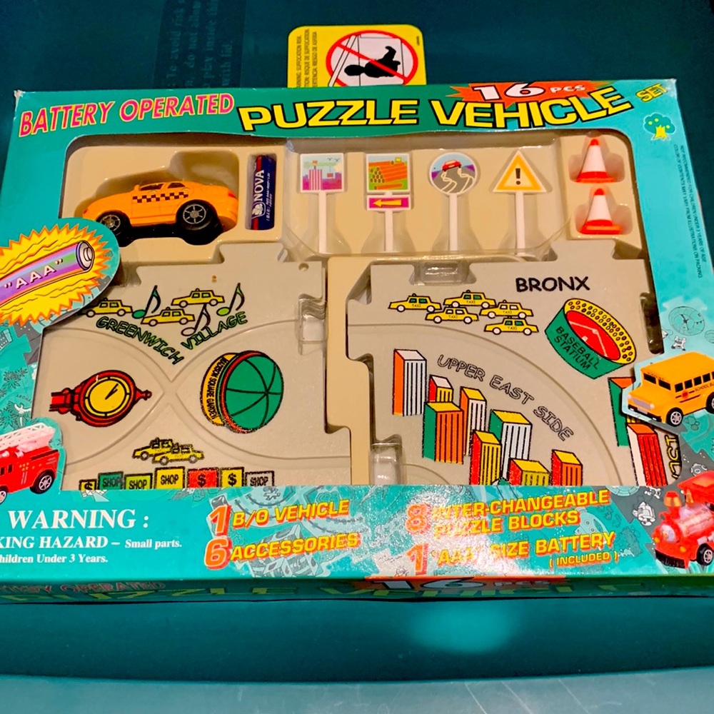 New Vintage Battery Operated 16 Piece Puzzle Vehicle Set.